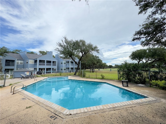 view of swimming pool featuring a patio area