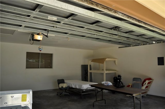 garage featuring a garage door opener and baseboards