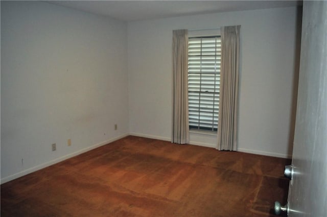 carpeted empty room with baseboards