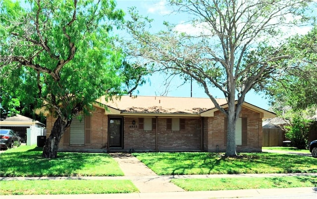ranch-style house featuring brick siding