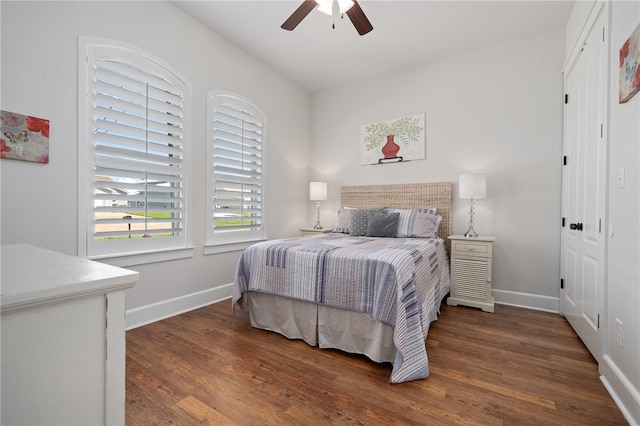 bedroom with ceiling fan and dark hardwood / wood-style floors