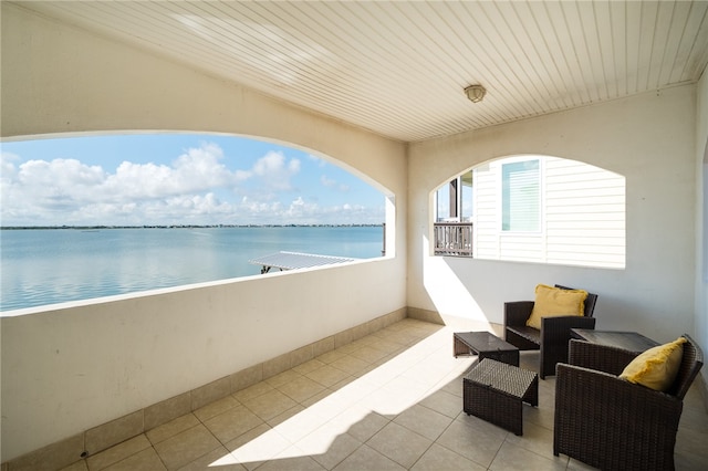 balcony featuring outdoor lounge area and a water view