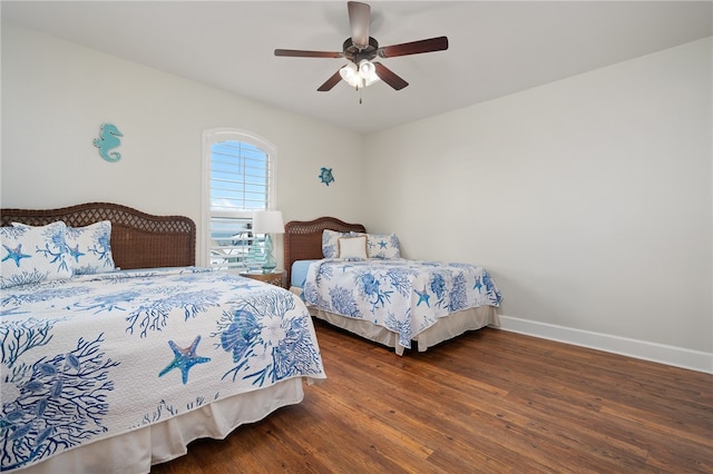 bedroom with dark hardwood / wood-style floors and ceiling fan