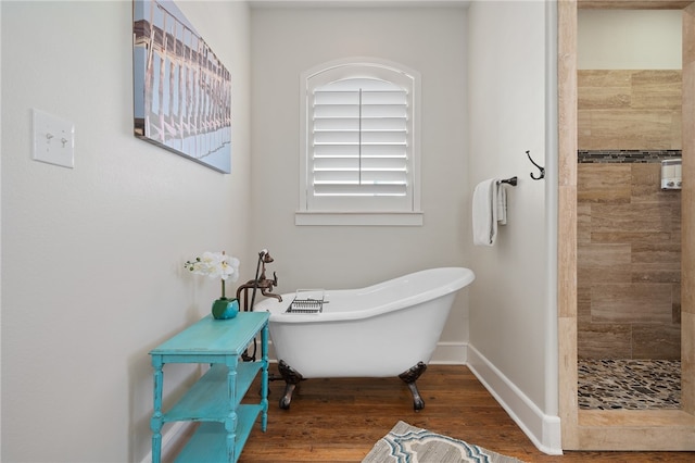 bathroom featuring hardwood / wood-style floors and plus walk in shower