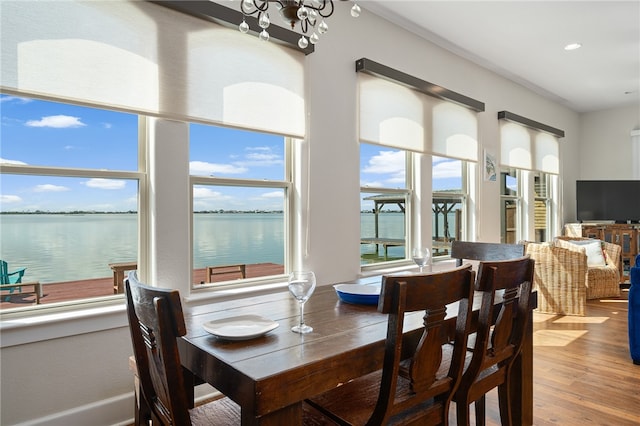 dining space with hardwood / wood-style flooring and a chandelier