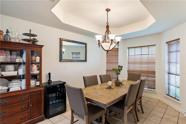 705 Aurora St, Bishop, TX 78343 - dining space with light tile patterned floors, a chandelier, a raised ceiling, wine cooler, and baseboards