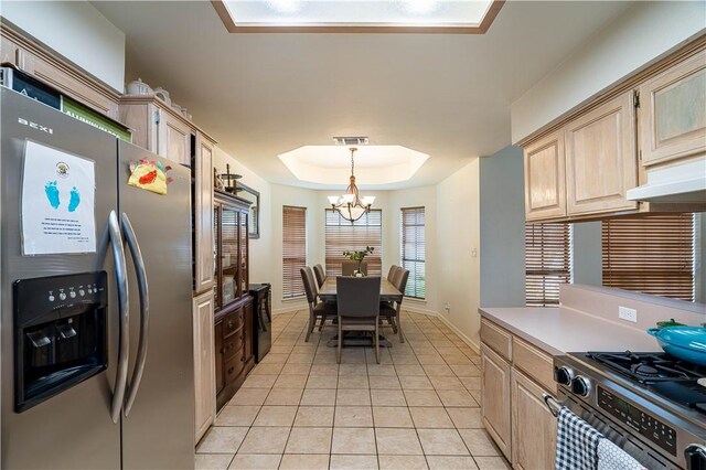 705 Aurora St, Bishop, TX 78343 - kitchen with stainless steel appliances, a chandelier, light brown cabinets, light tile patterned floors, and a raised ceiling