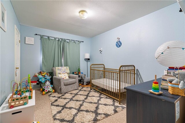705 Aurora St, Bishop, TX 78343 - bedroom featuring carpet floors and a crib