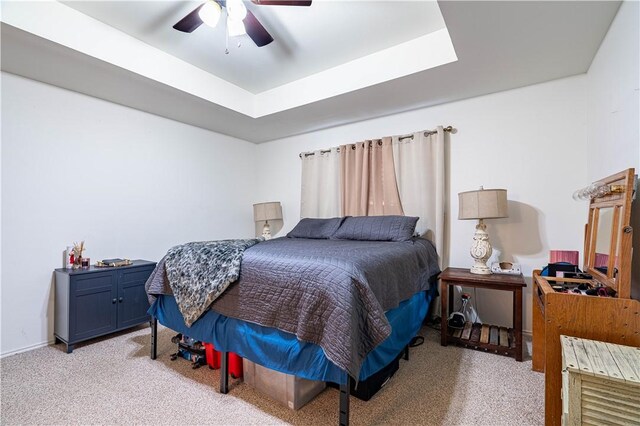 705 Aurora St, Bishop, TX 78343 - bedroom featuring light colored carpet, a ceiling fan, and a tray ceiling