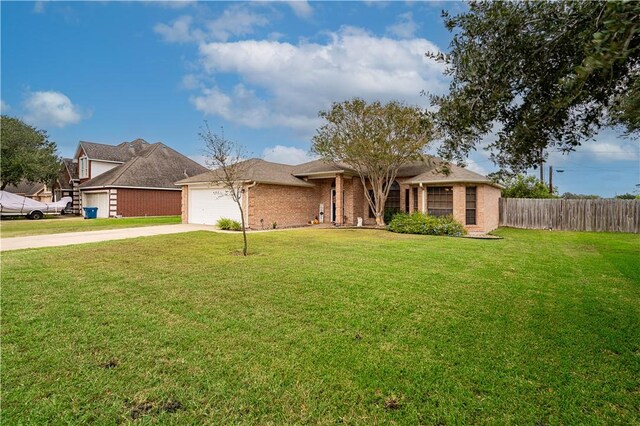 705 Aurora St, Bishop, TX 78343 - view of front of home with concrete driveway, a garage, and brick siding