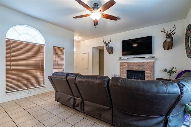 705 Aurora St, Bishop, TX 78343 - living room featuring ceiling fan, light tile patterned flooring, and a fireplace
