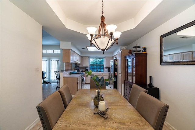 705 Aurora St, Bishop, TX 78343 - dining space with a raised ceiling, a chandelier, light tile patterned floors, and baseboards