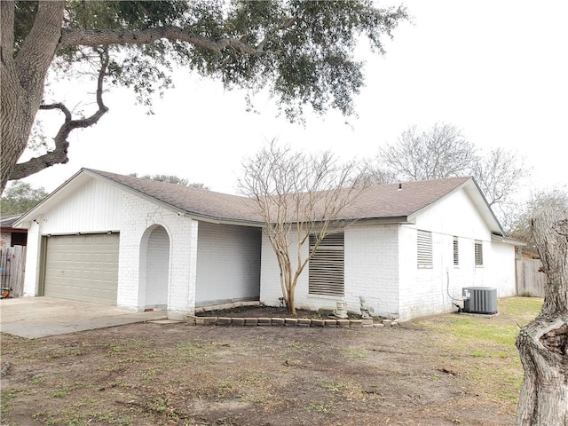 ranch-style house featuring central AC and a garage