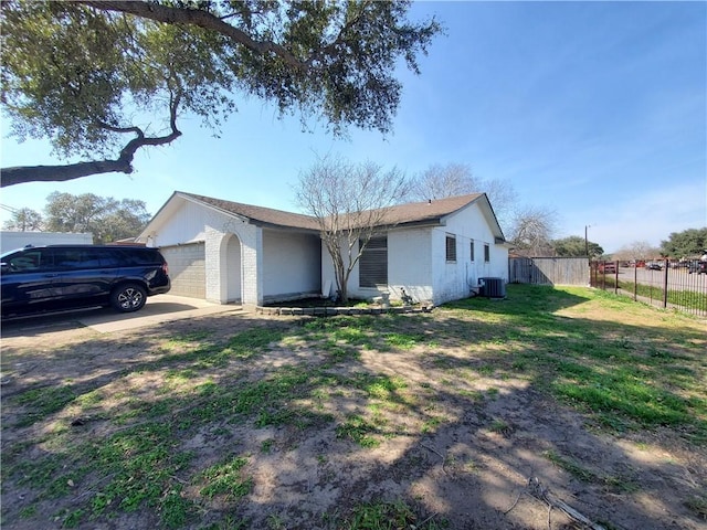 ranch-style house with brick siding, central air condition unit, fence, a garage, and a front lawn