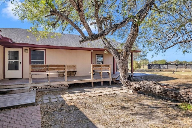 rear view of property featuring a deck