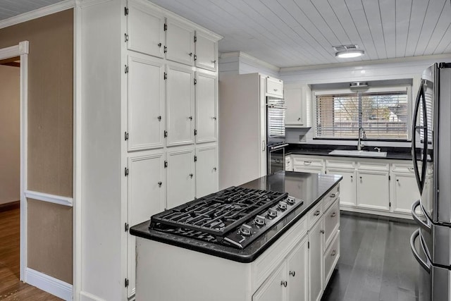 kitchen featuring sink, white cabinets, dark wood-type flooring, and appliances with stainless steel finishes