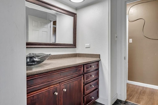 bathroom with hardwood / wood-style floors and vanity