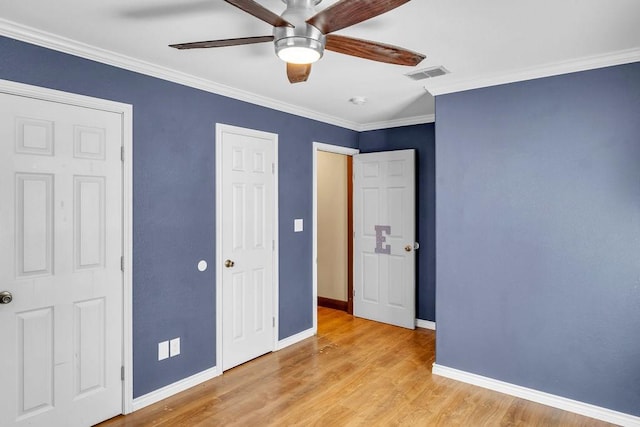 unfurnished bedroom featuring ceiling fan, light wood-type flooring, and ornamental molding