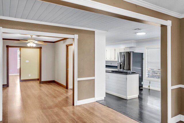 kitchen with light wood-type flooring, ceiling fan, crown molding, wooden ceiling, and white cabinetry