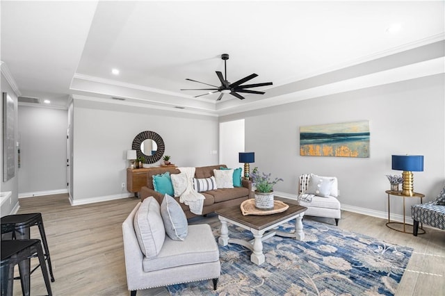 7721 Keiras Way, Corpus Christi, TX 78414 - living area with a raised ceiling, crown molding, ceiling fan, baseboards, and wood finished floors