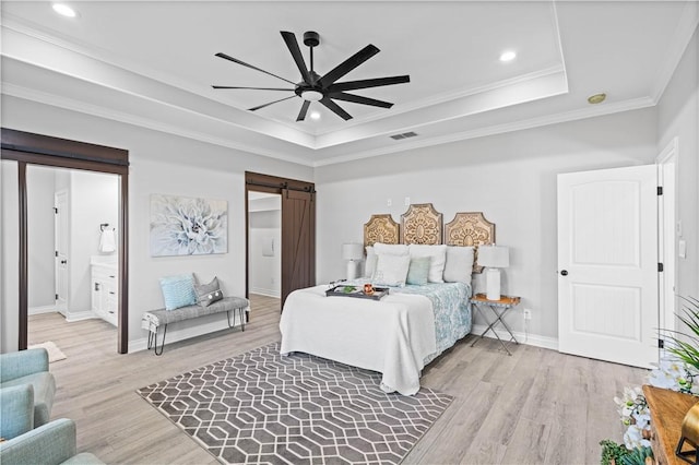 7721 Keiras Way, Corpus Christi, TX 78414 - bedroom with a barn door, a raised ceiling, light wood finished floors, baseboards, and ornamental molding