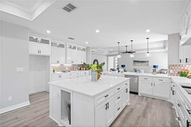 7721 Keiras Way, Corpus Christi, TX 78414 - kitchen featuring a raised ceiling, stainless steel dishwasher, a peninsula, recessed lighting, and light wood-style flooring