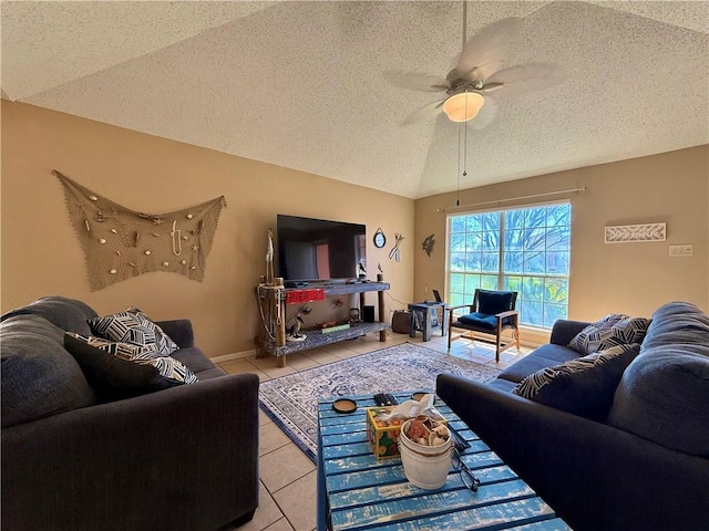 living area featuring a ceiling fan, vaulted ceiling, a textured ceiling, and light tile patterned floors