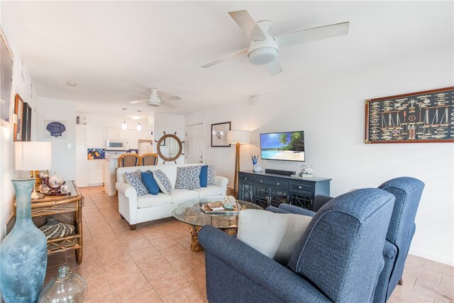 living room with ceiling fan and light tile patterned flooring