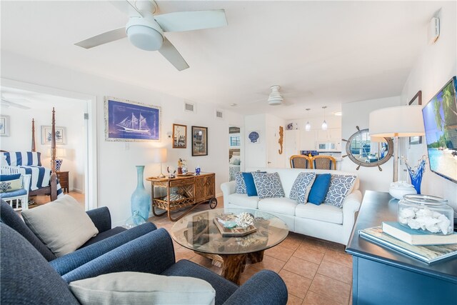 tiled living room with ceiling fan