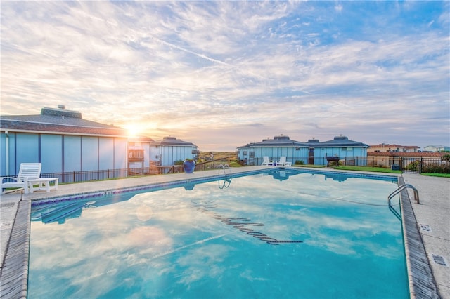 view of pool at dusk