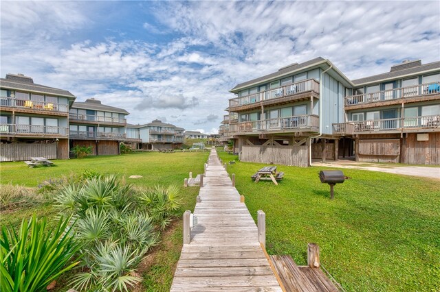 back of property featuring a lawn and a balcony