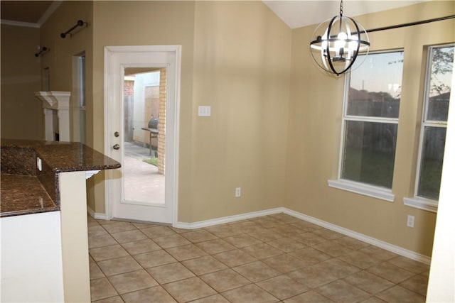 unfurnished dining area featuring a healthy amount of sunlight, light tile patterned floors, and a chandelier