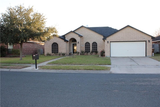 view of front of house featuring a front yard and a garage