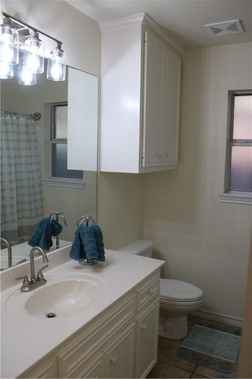 bathroom with tile patterned floors, vanity, and toilet