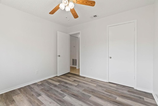 1134 Harbor Village Dr, Corpus Christi, TX 78412 - unfurnished bedroom featuring wood finished floors, ceiling fan, and baseboards
