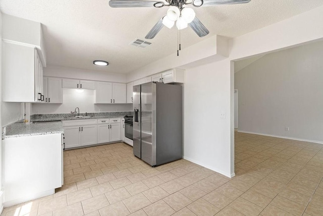 1134 Harbor Village Dr, Corpus Christi, TX 78412 - kitchen featuring stainless steel fridge with ice dispenser, a ceiling fan, a sink, white cabinetry, and light stone counters