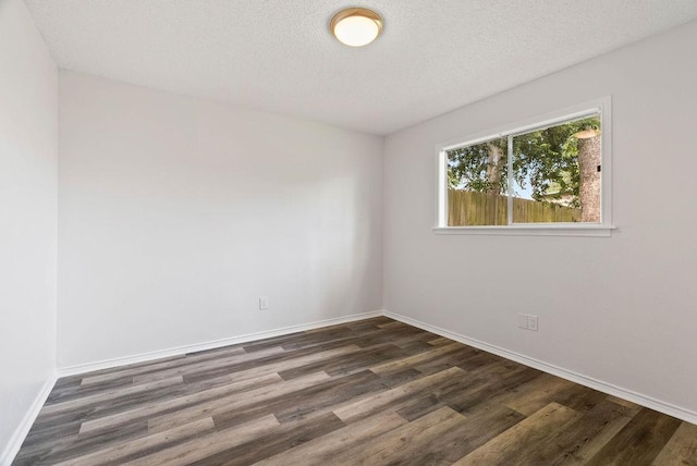1134 Harbor Village Dr, Corpus Christi, TX 78412 - empty room with dark wood-style flooring, baseboards, and a textured ceiling