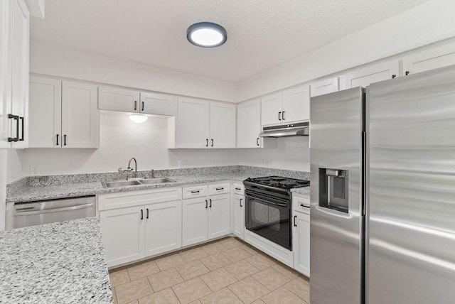 1134 Harbor Village Dr, Corpus Christi, TX 78412 - kitchen with stainless steel appliances, a sink, under cabinet range hood, white cabinets, and light tile patterned floors