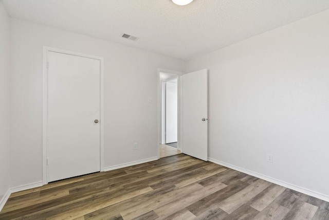 1134 Harbor Village Dr, Corpus Christi, TX 78412 - unfurnished bedroom with wood finished floors and baseboards