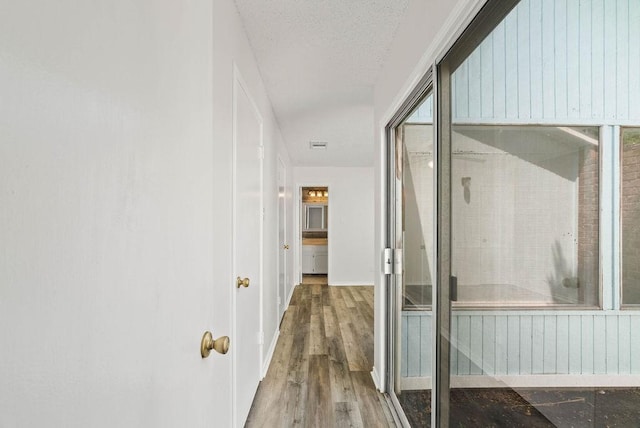 1134 Harbor Village Dr, Corpus Christi, TX 78412 - corridor with wood finished floors, baseboards, and a textured ceiling