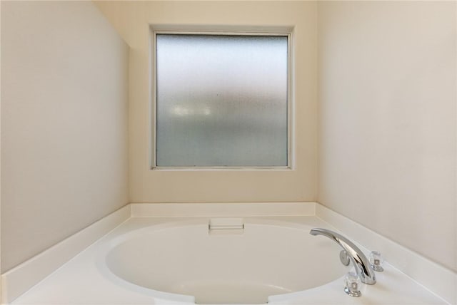 bathroom featuring a washtub