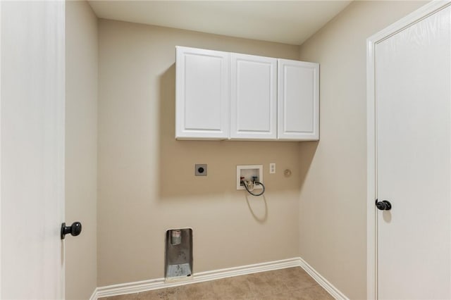 clothes washing area featuring cabinet space, hookup for a washing machine, electric dryer hookup, and baseboards