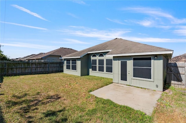 back of house featuring a yard, a fenced backyard, and a patio