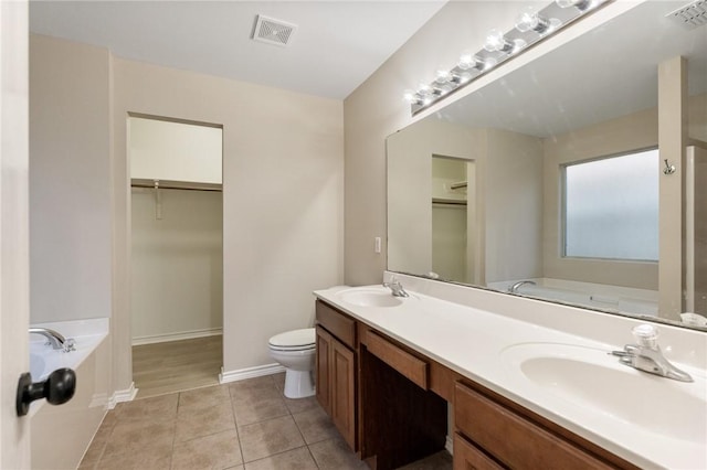 full bathroom with visible vents, a walk in closet, and a sink