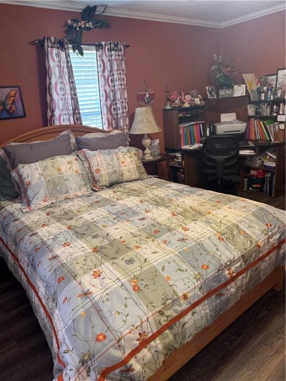 bedroom featuring wood finished floors and crown molding