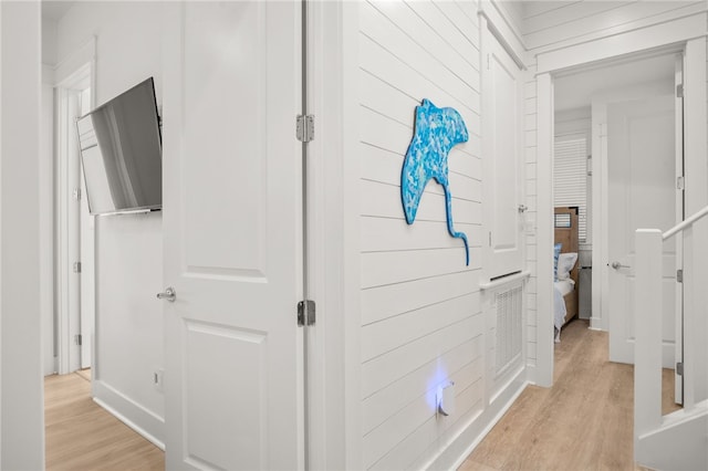 hallway featuring light wood-style flooring and visible vents