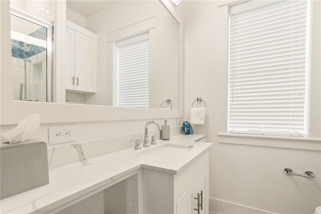 bathroom featuring a shower stall and vanity