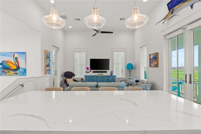 living area featuring recessed lighting, french doors, and visible vents