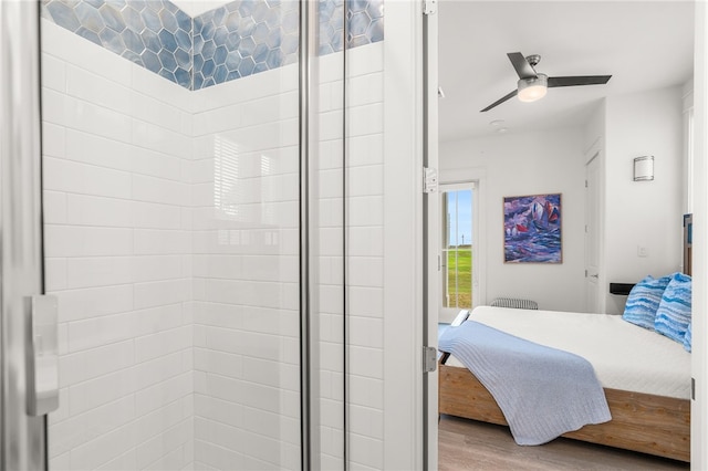 bedroom featuring ceiling fan, wood finished floors, and access to exterior