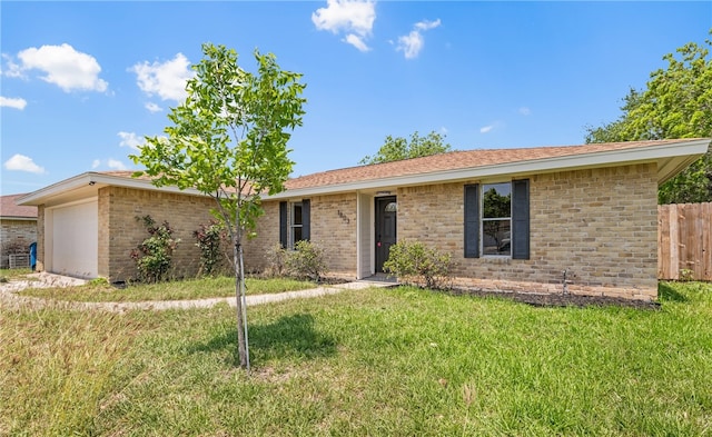 ranch-style home featuring brick siding, a garage, a front lawn, and fence